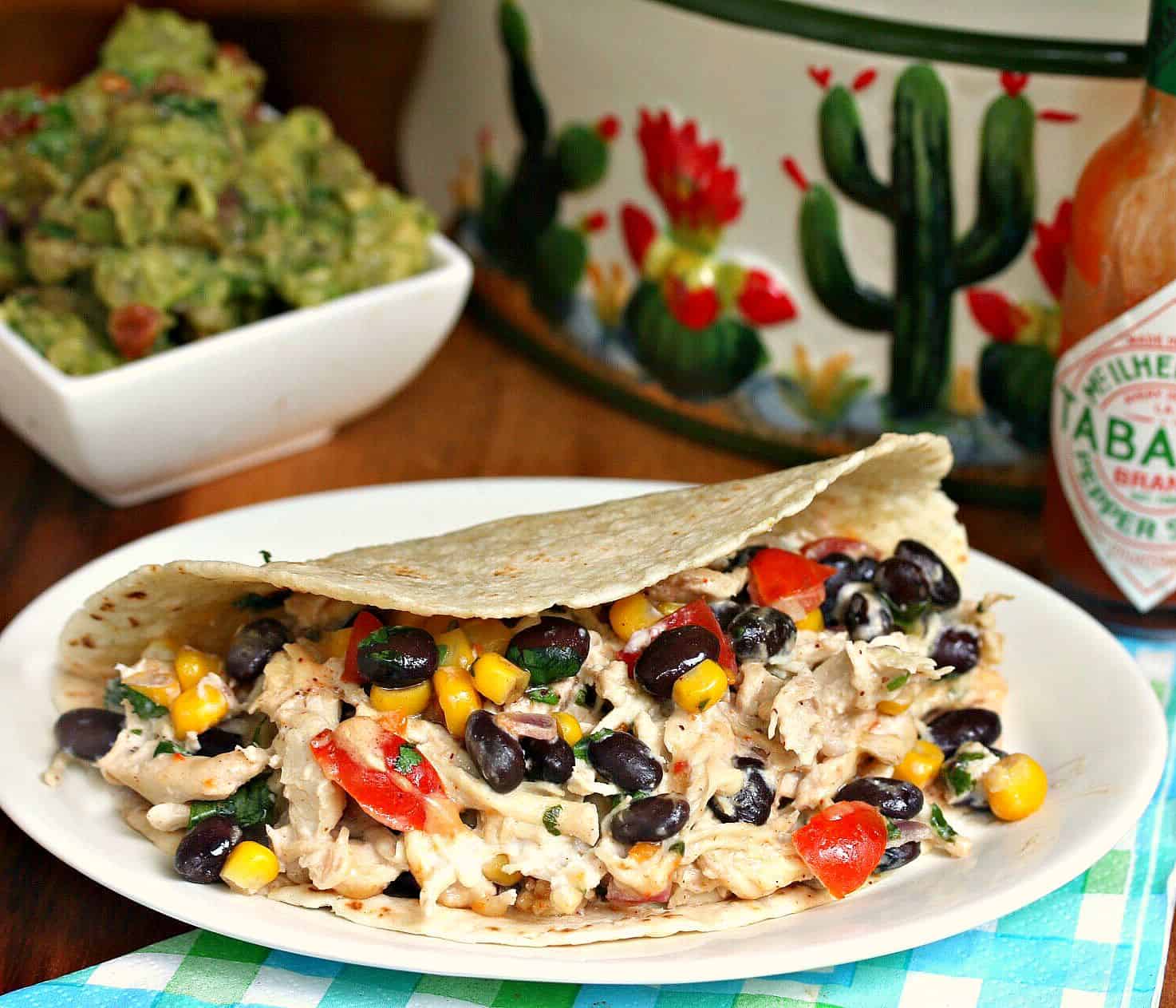 These crock pot chicken tacos are loaded with shredded chicken and a creamy taco mixture full of your favorite Mexican flavors! This is delicious over lettuce wraps, rice, or taco shells! Crock-pot-Chicken-Tacos