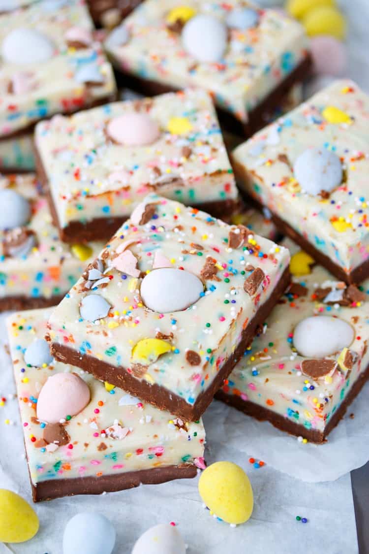 This Easy Easter Fudge has two luscious layers of chocolate mixed with sprinkles and topped with Cadbury mini eggs. A fun Easter dessert that's easy to customize and fun to make! Easy-Easter-Fudge