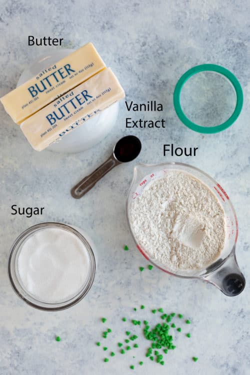 Overhead shot of butter, sugar, flour, and vanilla extract to make shortbread cookies