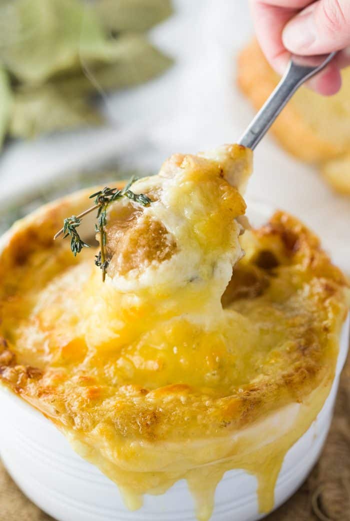This instant pot french onion soup features perfectly caramelized onions in a rich, dark broth topped with a toasted baguette and hot and bubbly Gruyere cheese. French-Onion-Soup