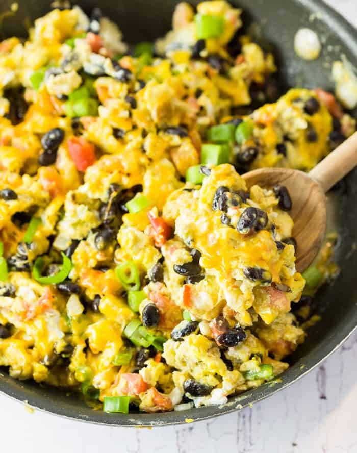 These soft and fluffy scranbled eggs are served with classic Mexican favorites like black beans, tomatoes, onions, and cheese. Mexican-Egg-Scramble