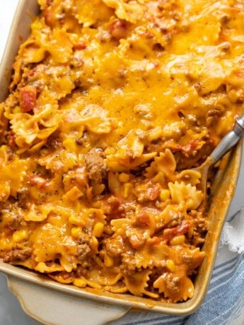Sloppy joe casserole in a casserole dish with a spoon scooping it up.