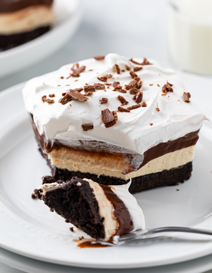 A white plate with Peanut Butter Delight on top with a fork.