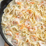 A skillet of Shrimp Alfredo with Fettucine pasta.