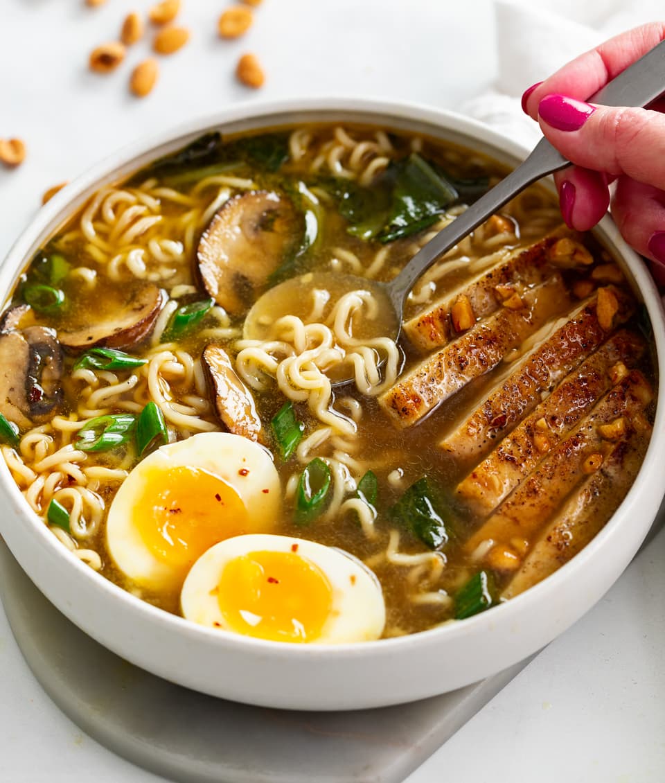 Homemade Ramen Soup in a bowl with a spoon in it.