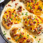 Bacon Ranch Chicken in ranch sauce with melted cheese, bacon, and green onions.
